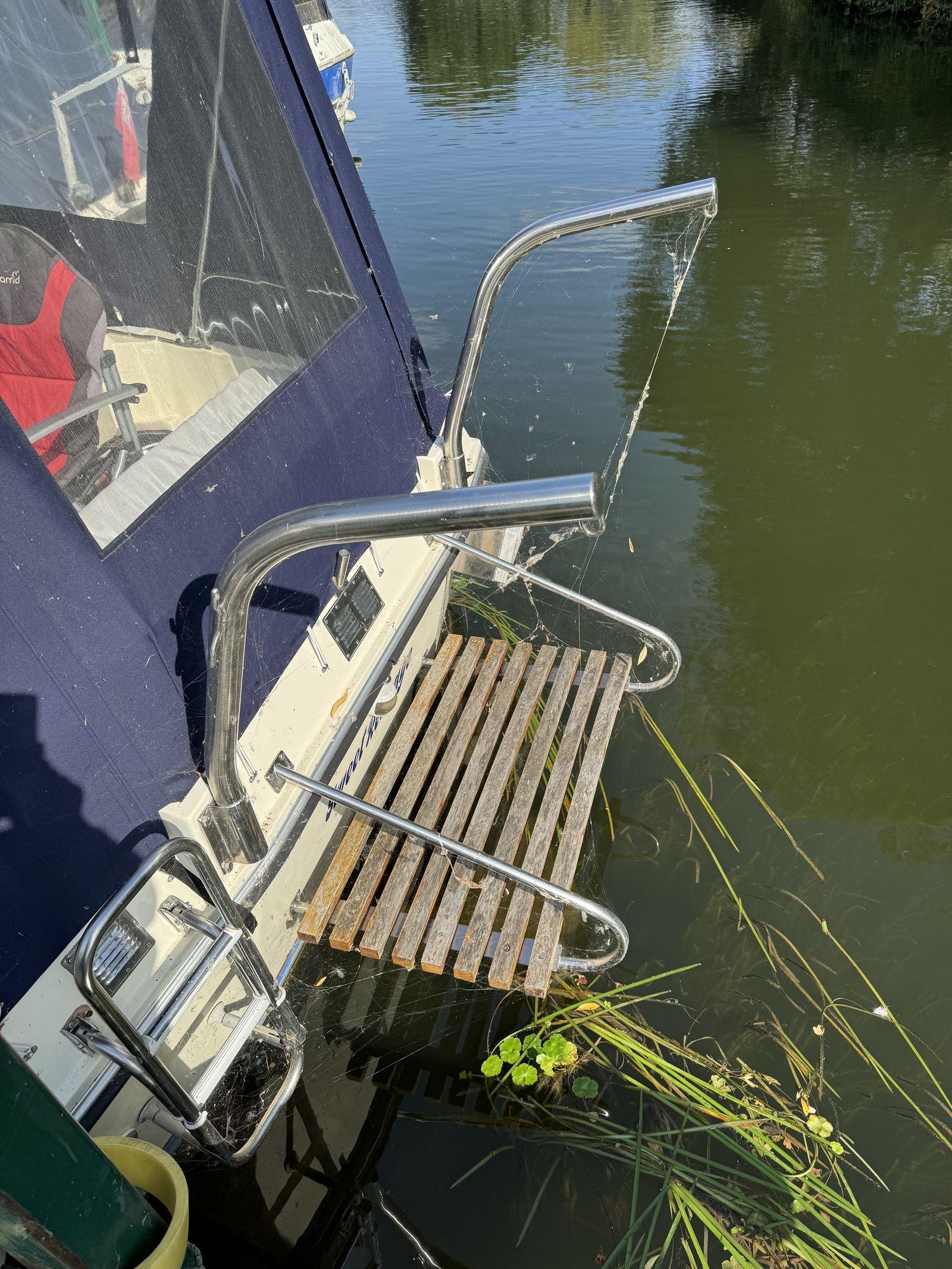 The stern of “Sweet Revenge”, showing the slatted bathing platform and stainless rails over the water.
